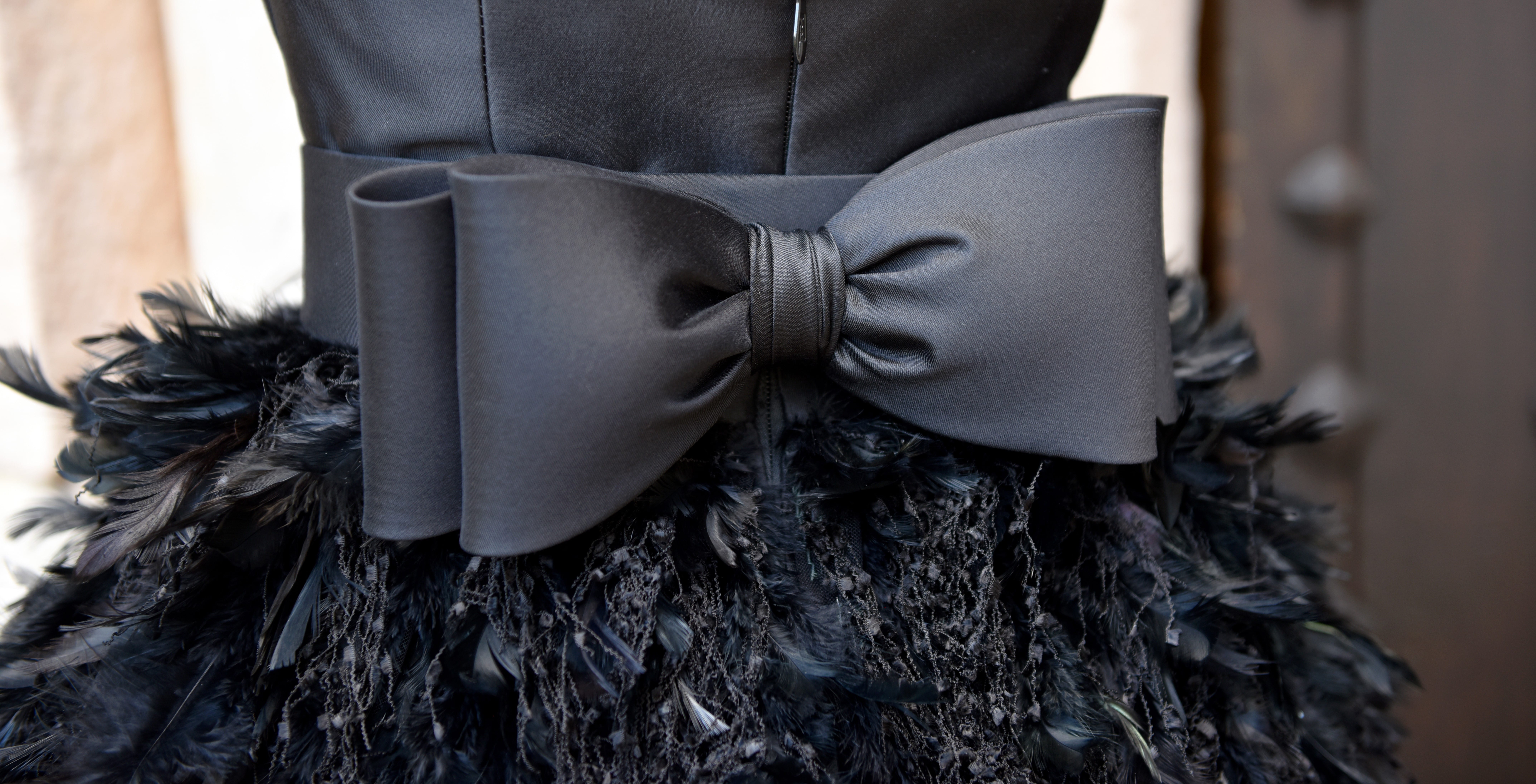 Black dress with big bow and feather details